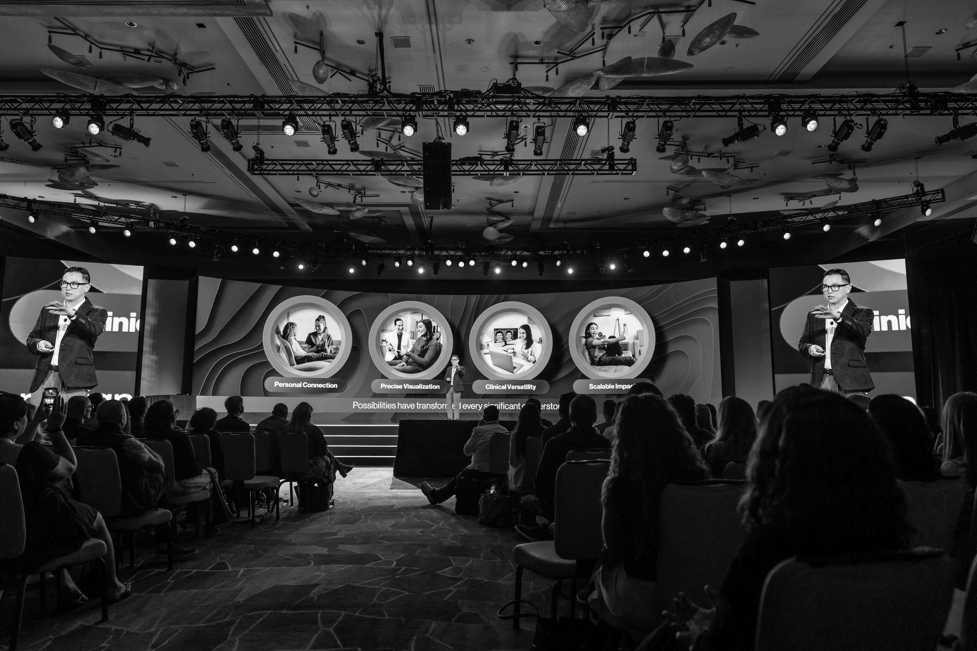 Dr. Sam Lee on stage with an audience of orthodontists